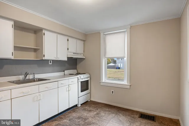 a kitchen with a sink cabinets and window