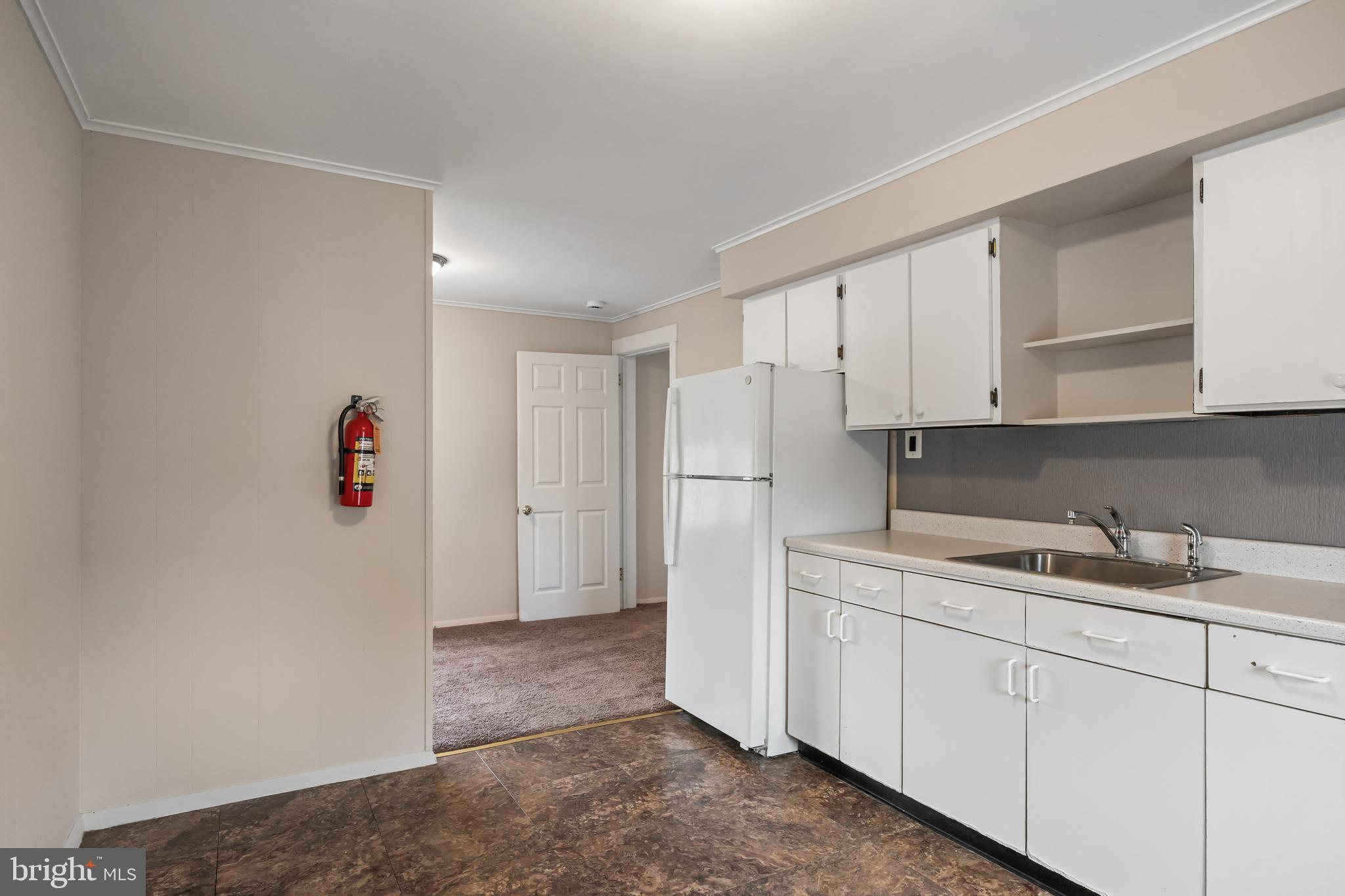 1500 Mt Holly Road, Unit 1F Burlington, NJ 08016 - Photo 15 of 21 a kitchen with a sink and refrigerator