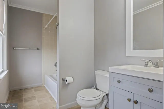 a bathroom with a sink a toilet a vanity and mirror