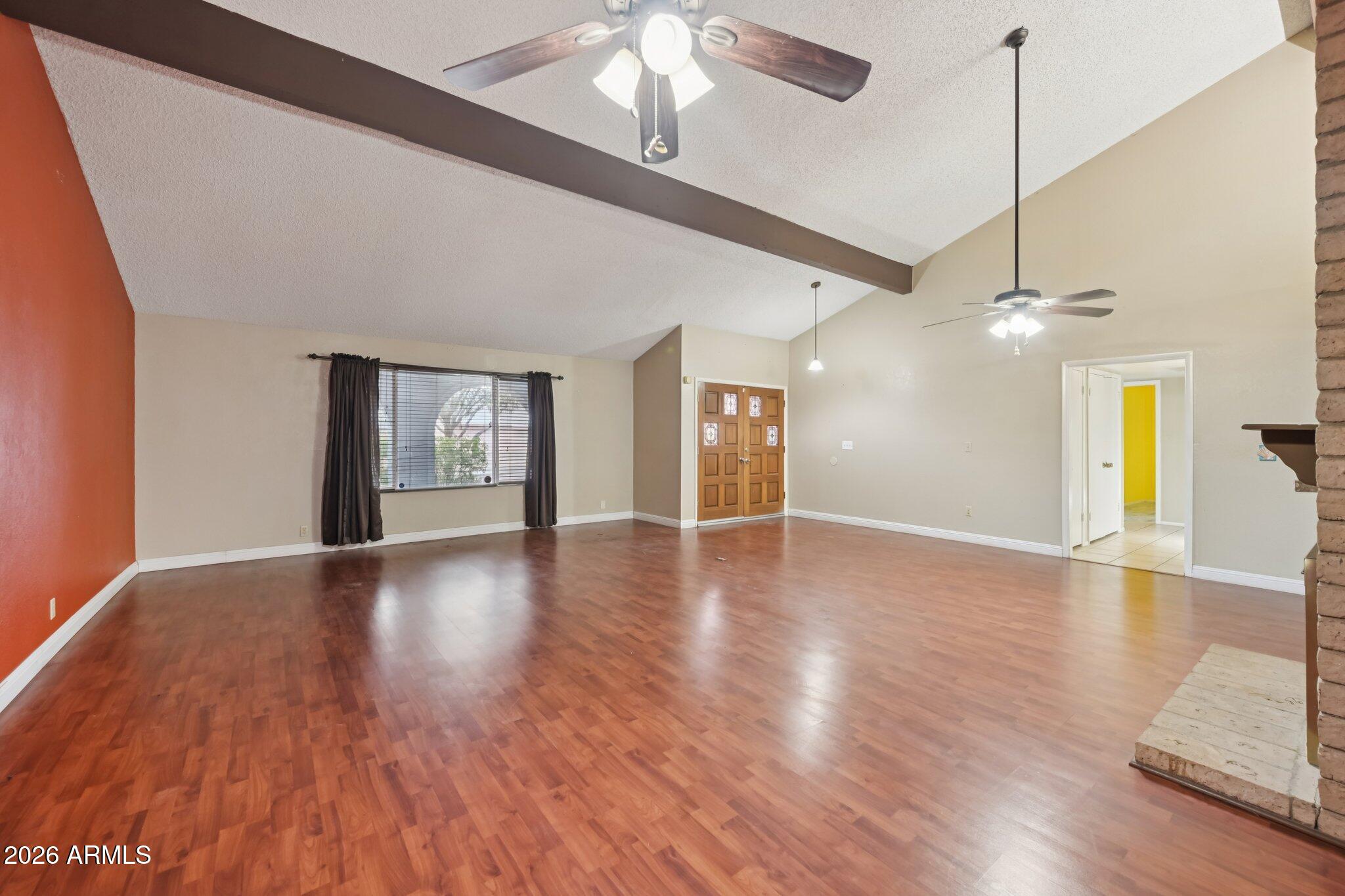 2201 West Utopia Road Phoenix, AZ 85027 - Photo 12 of 50 a view of an empty room with window and wooden floor