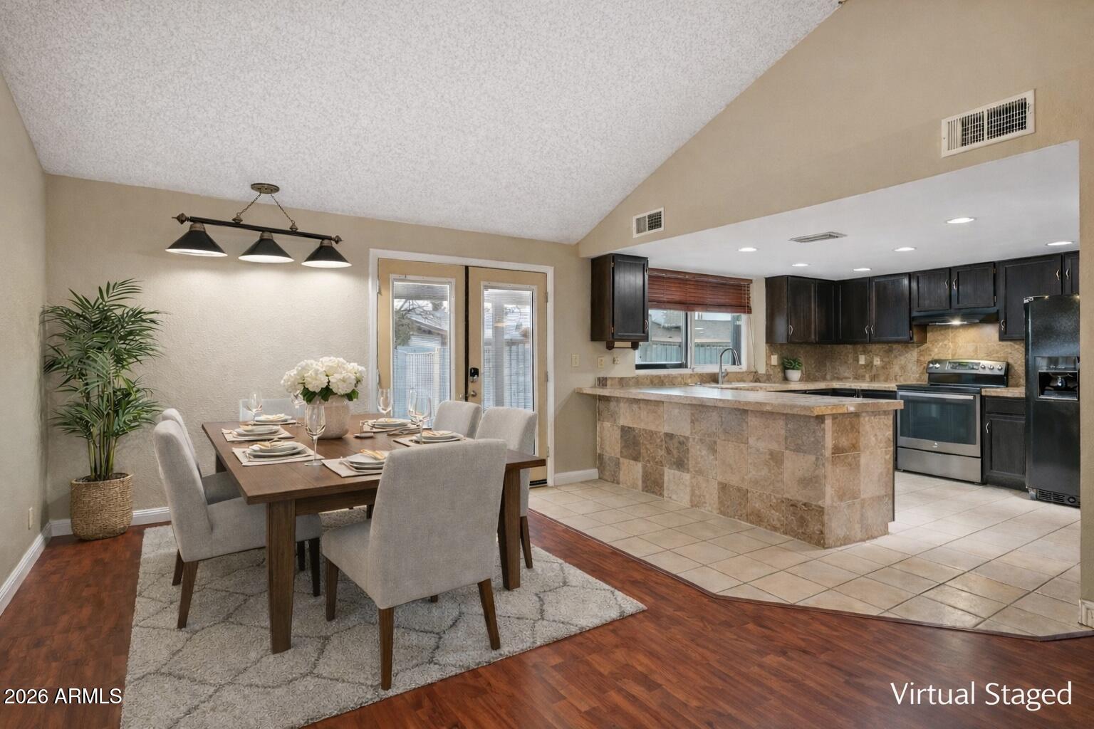 2201 West Utopia Road Phoenix, AZ 85027 - Photo 17 of 50 a dining room with kitchen island a table and chairs