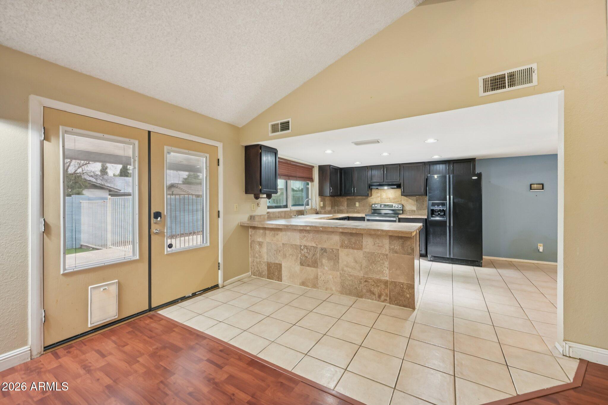 2201 West Utopia Road Phoenix, AZ 85027 - Photo 18 of 50 a large white kitchen with a sink and refrigerator
