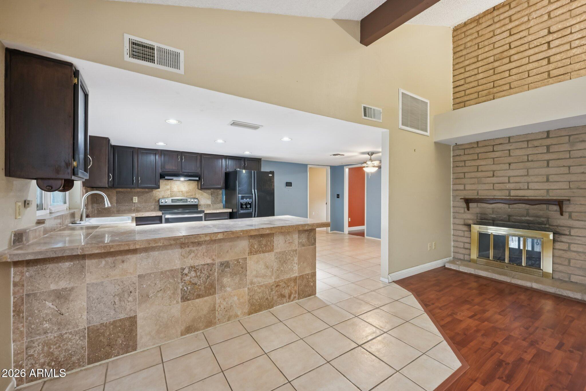 2201 West Utopia Road Phoenix, AZ 85027 - Photo 20 of 50 a kitchen with stainless steel appliances kitchen island granite countertop a sink and cabinets