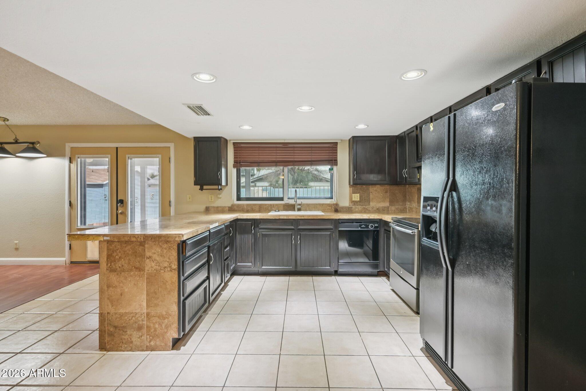 2201 West Utopia Road Phoenix, AZ 85027 - Photo 21 of 50 a kitchen with stainless steel appliances granite countertop a refrigerator and a sink