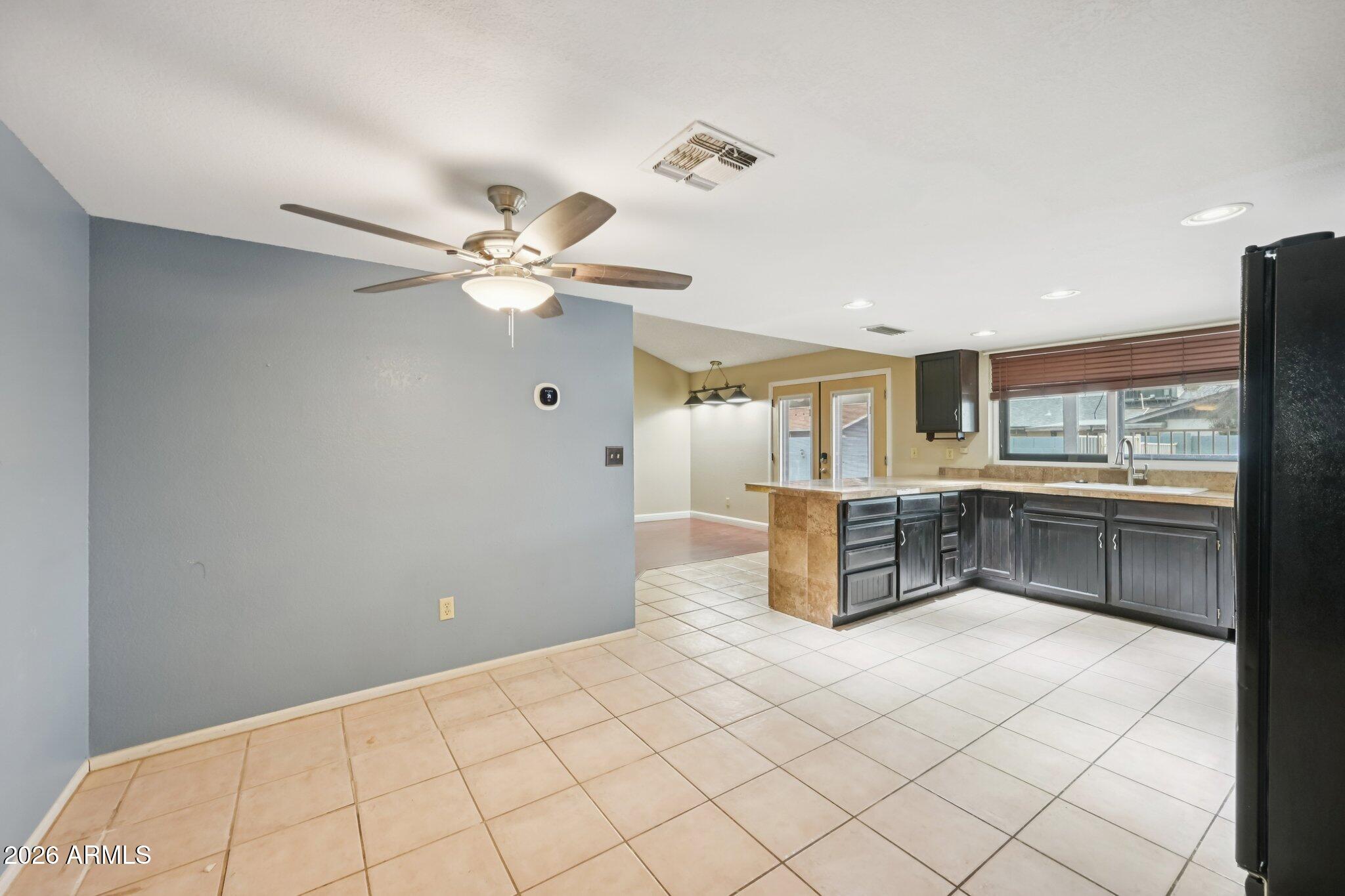 2201 West Utopia Road Phoenix, AZ 85027 - Photo 23 of 50 a kitchen with stainless steel appliances a cabinets and chandelier