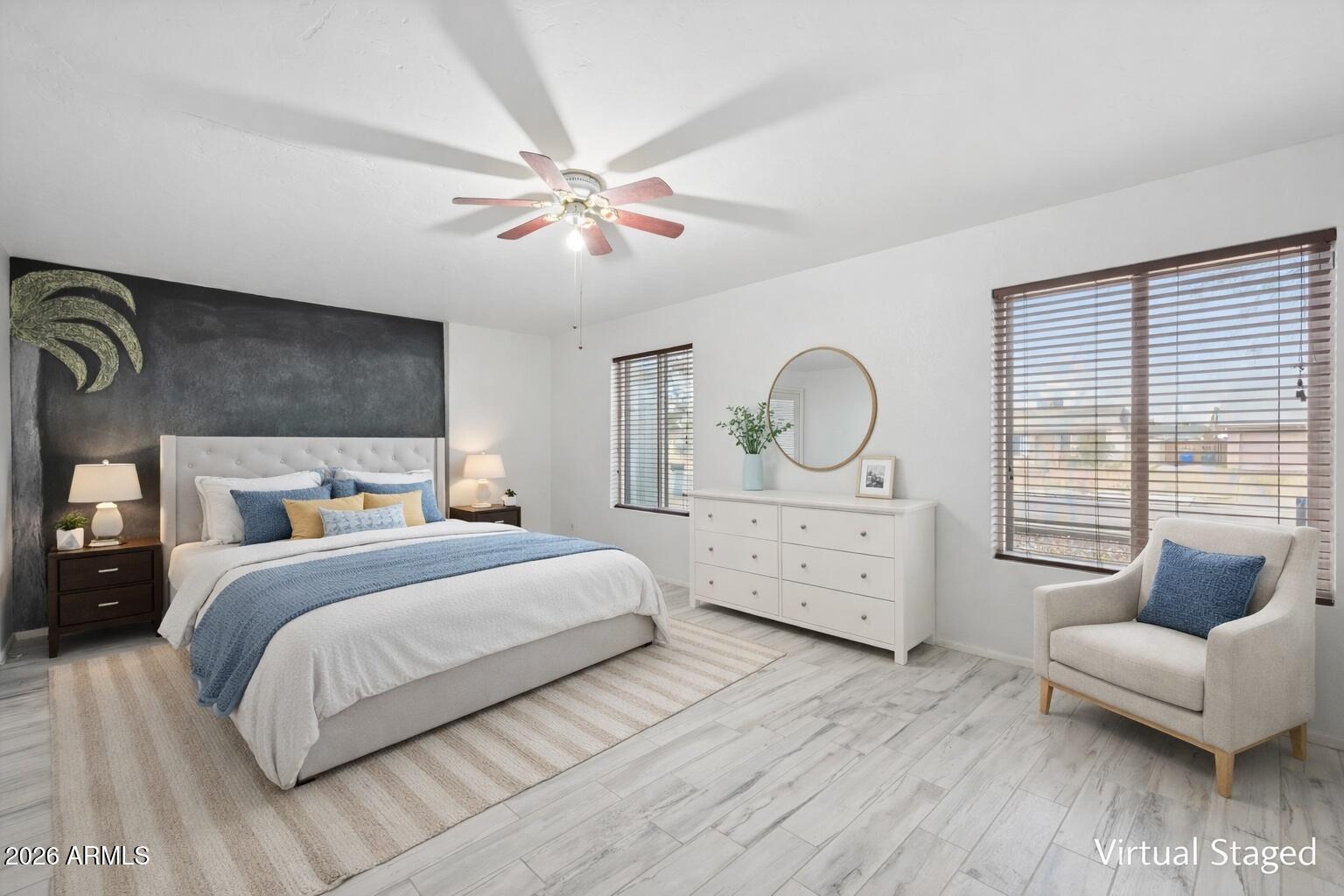 2201 West Utopia Road Phoenix, AZ 85027 - Photo 26 of 50 a spacious bedroom with a bed a dresser with wooden floor
