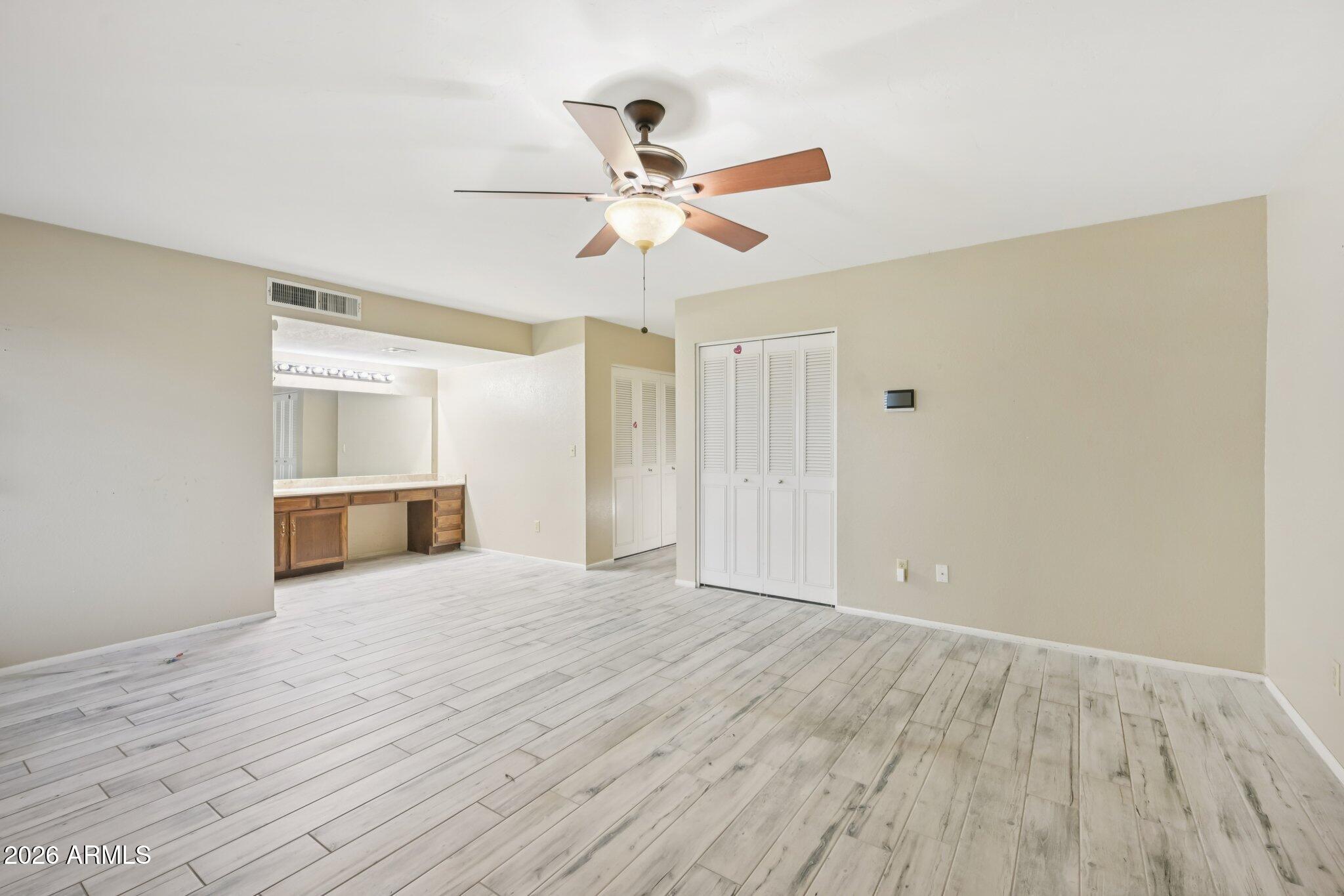 2201 West Utopia Road Phoenix, AZ 85027 - Photo 32 of 50 a view of a livingroom with a ceiling fan and wooden floor