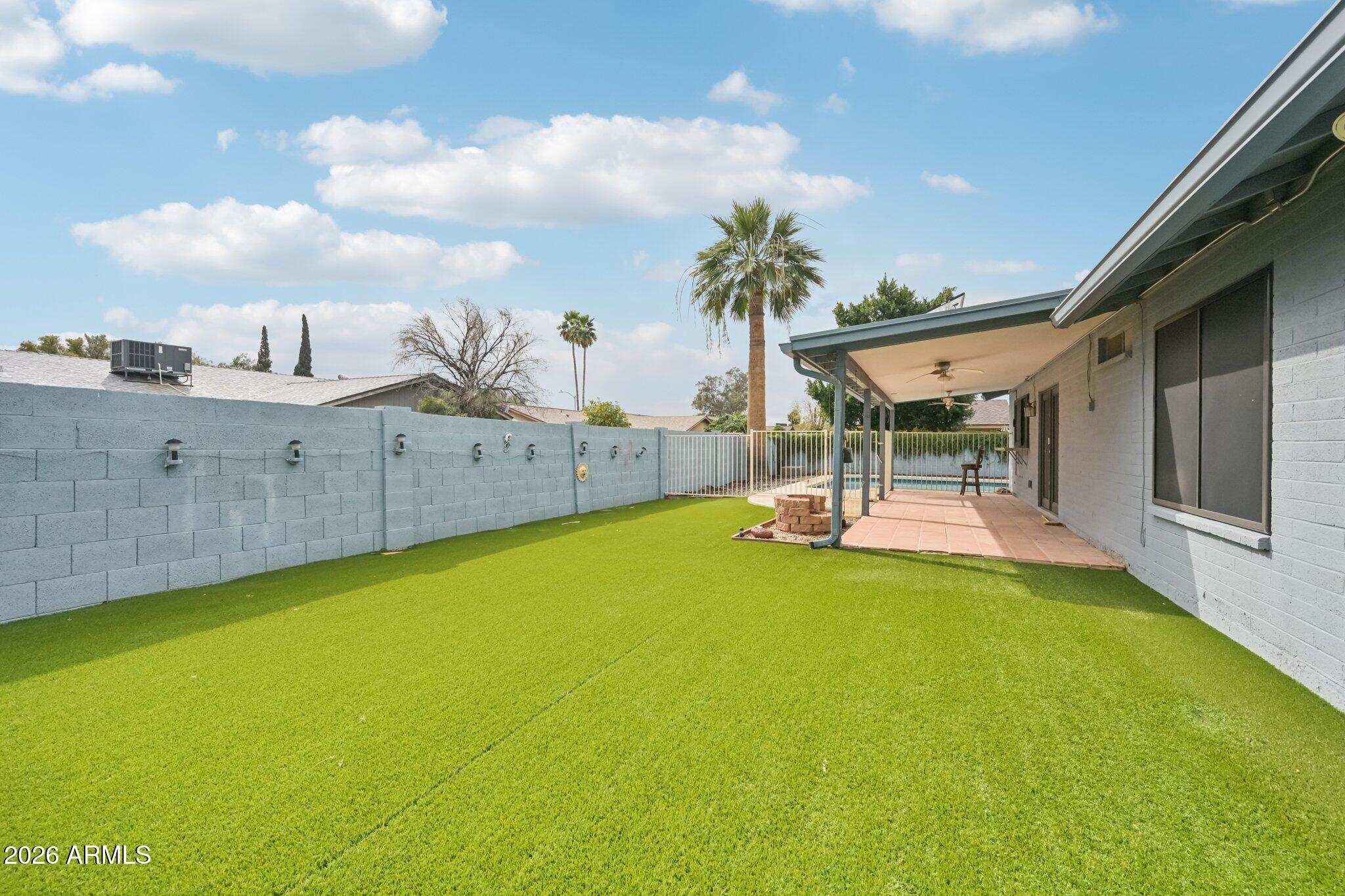 2201 West Utopia Road Phoenix, AZ 85027 - Photo 42 of 50 a view of a swimming pool with an outdoor seating and house in the background