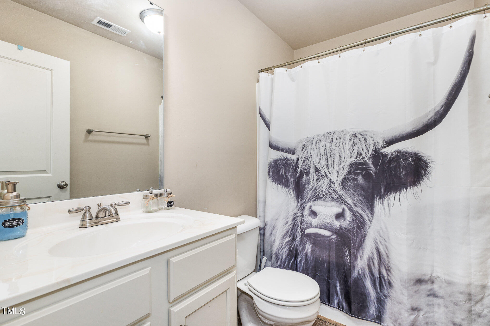 6005 Zacks Mill Road Angier, NC 27501 - Photo 18 of 23 a bathroom with a toilet sink and mirror