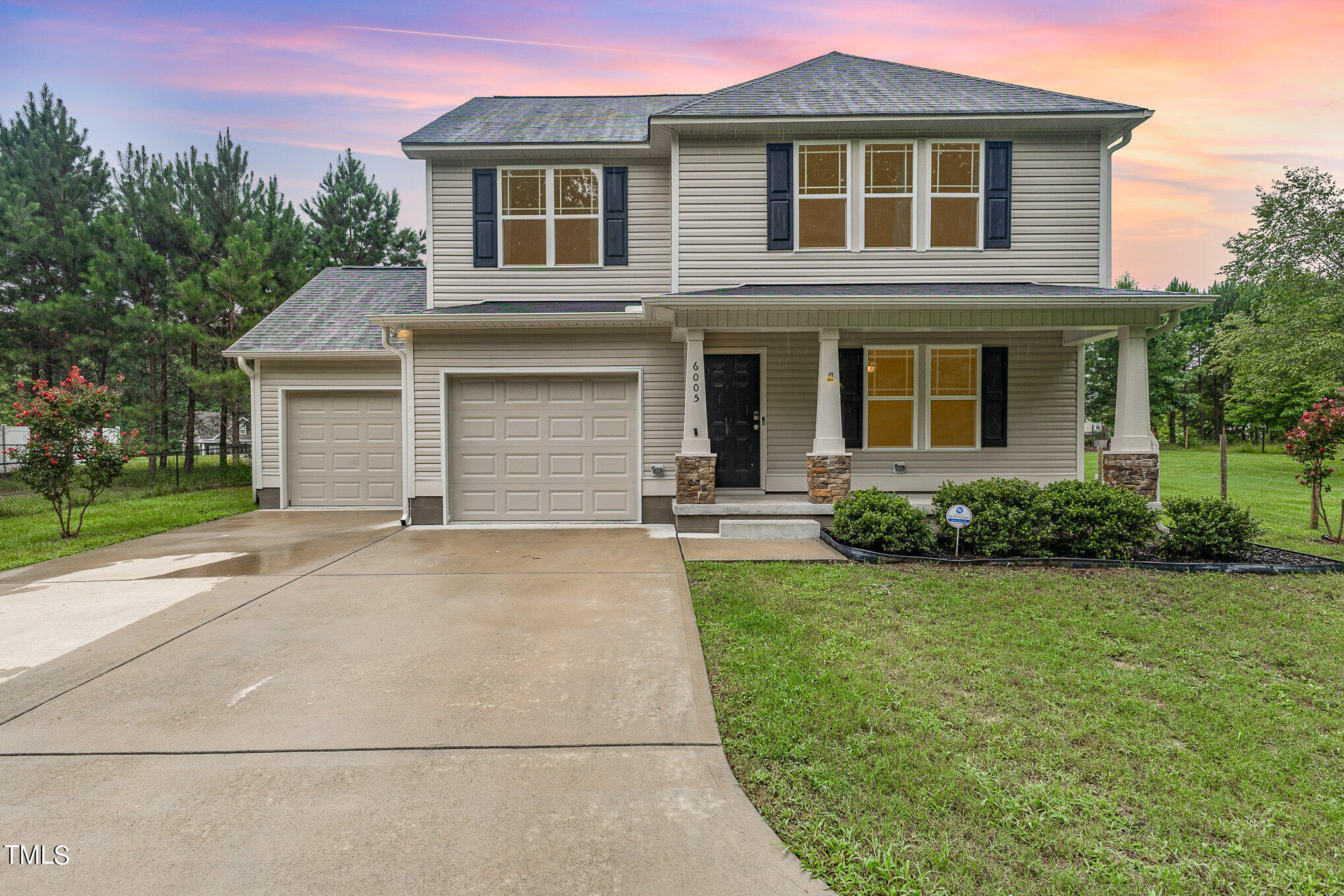 6005 Zacks Mill Road Angier, NC 27501 - Photo 2 of 23 a front view of a house with a yard and garage