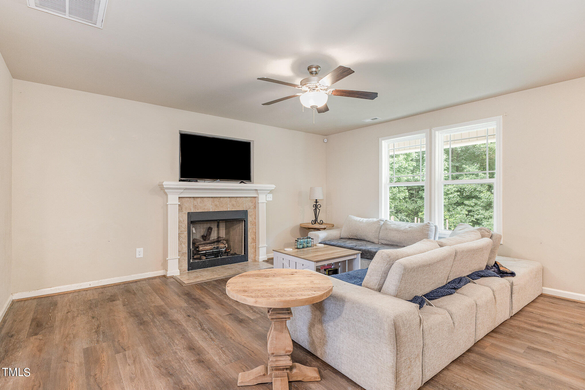 6005 Zacks Mill Road Angier, NC 27501 - Photo 6 of 23 a living room with furniture a fireplace and a flat screen tv
