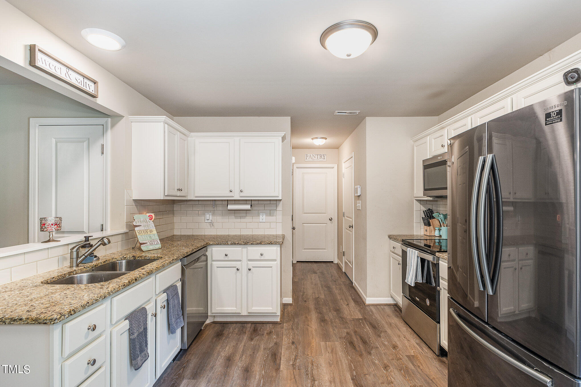 6005 Zacks Mill Road Angier, NC 27501 - Photo 8 of 23 a kitchen with a sink stove and refrigerator