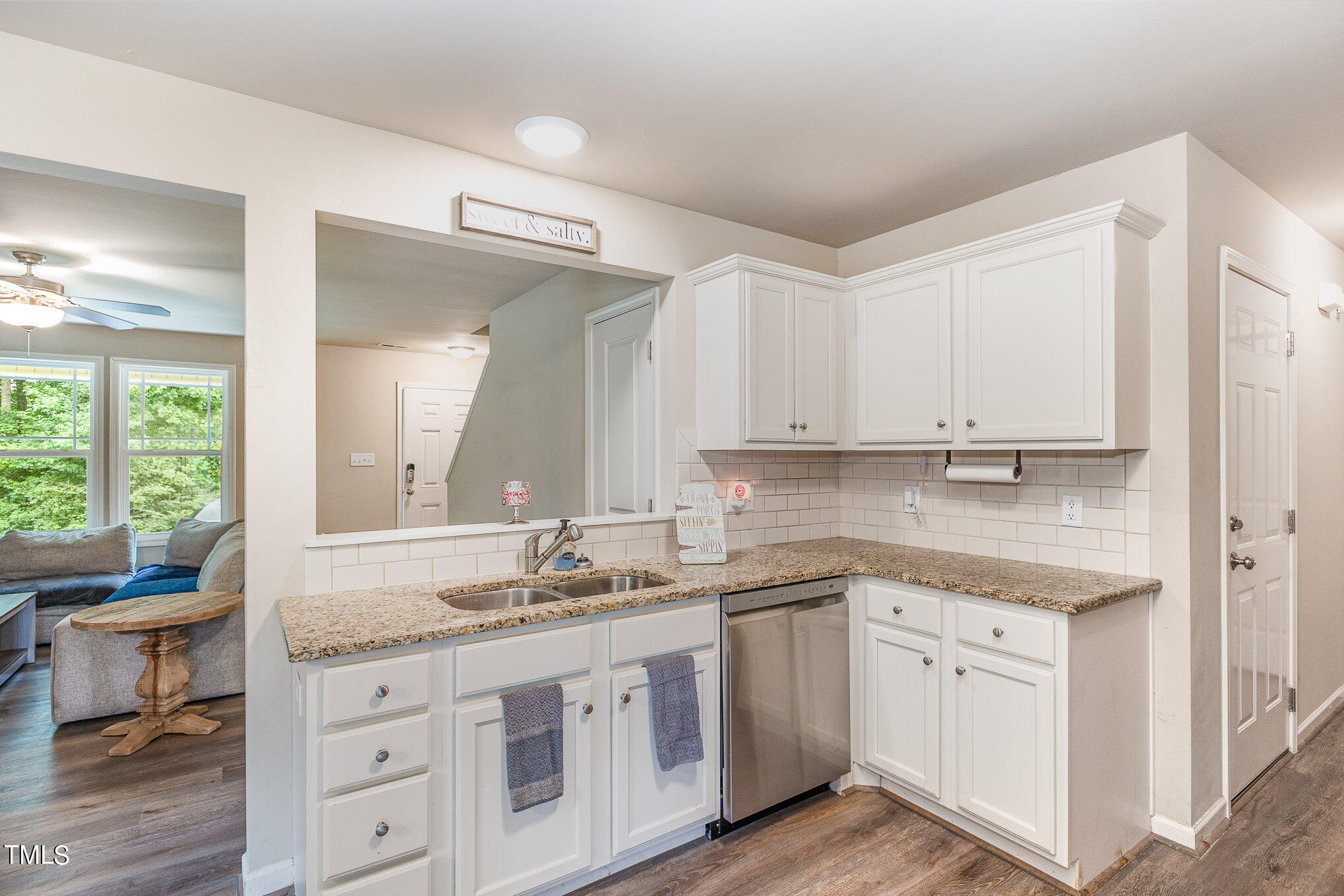 6005 Zacks Mill Road Angier, NC 27501 - Photo 9 of 23 a kitchen with granite countertop white cabinets white appliances a sink and a large window
