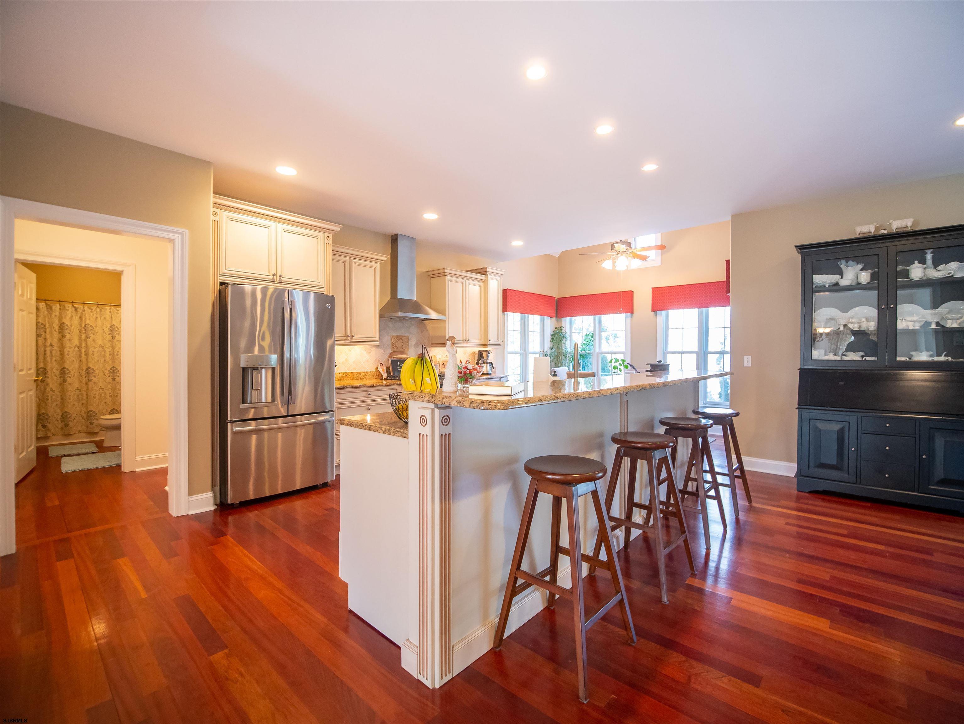 9 MGM Way Ocean View, NJ 08230 - Photo 11 of 61 a kitchen with stainless steel appliances a dining table chairs refrigerator and sink