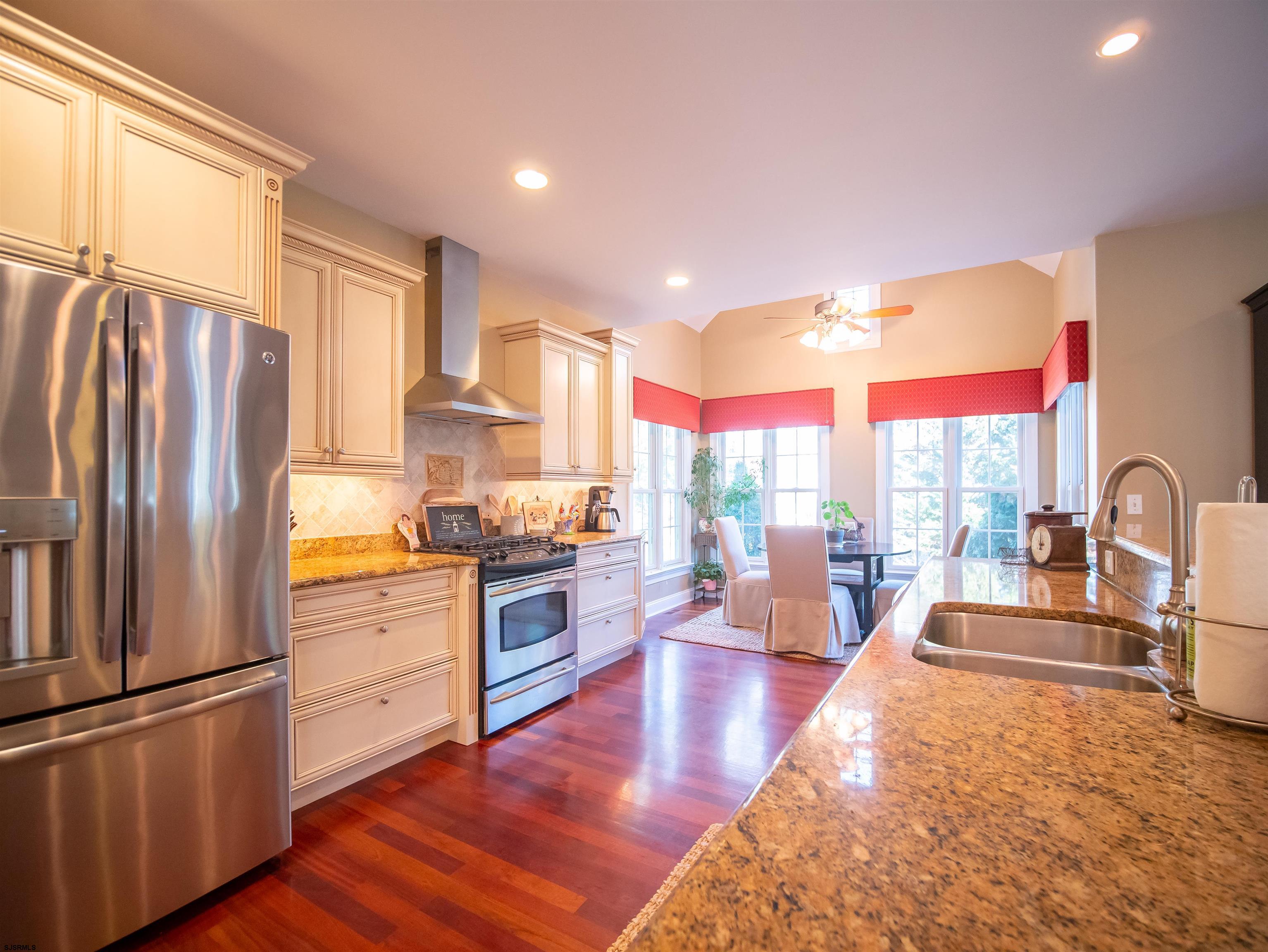 9 MGM Way Ocean View, NJ 08230 - Photo 15 of 61 a kitchen with stainless steel appliances granite countertop a refrigerator a stove and a wooden floors