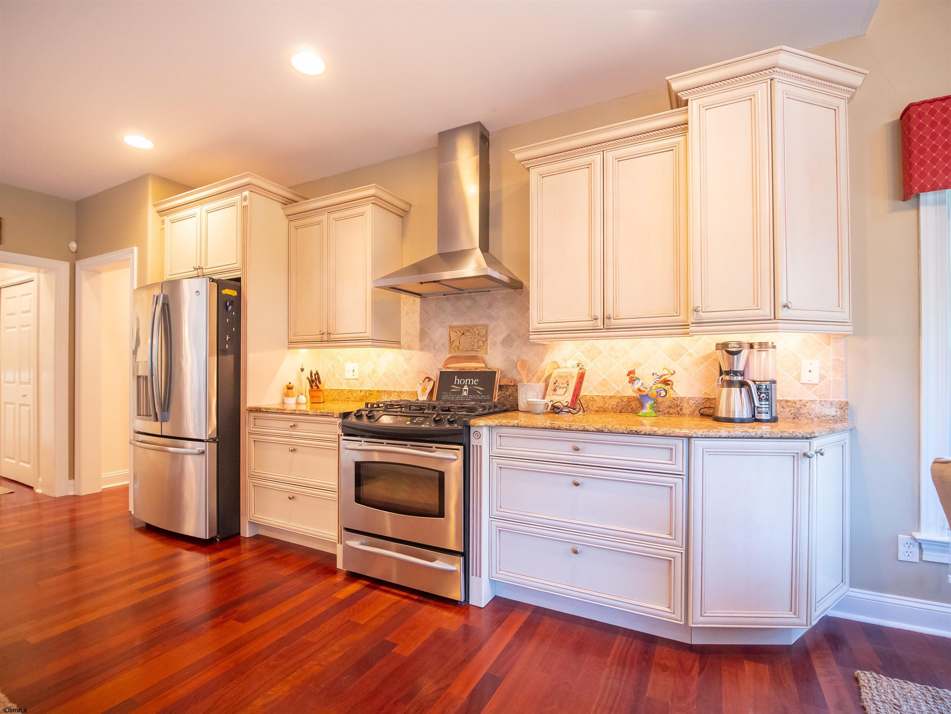 9 MGM Way Ocean View, NJ 08230 - Photo 19 of 61 a kitchen with stainless steel appliances granite countertop a stove a refrigerator and a stove with wooden floors