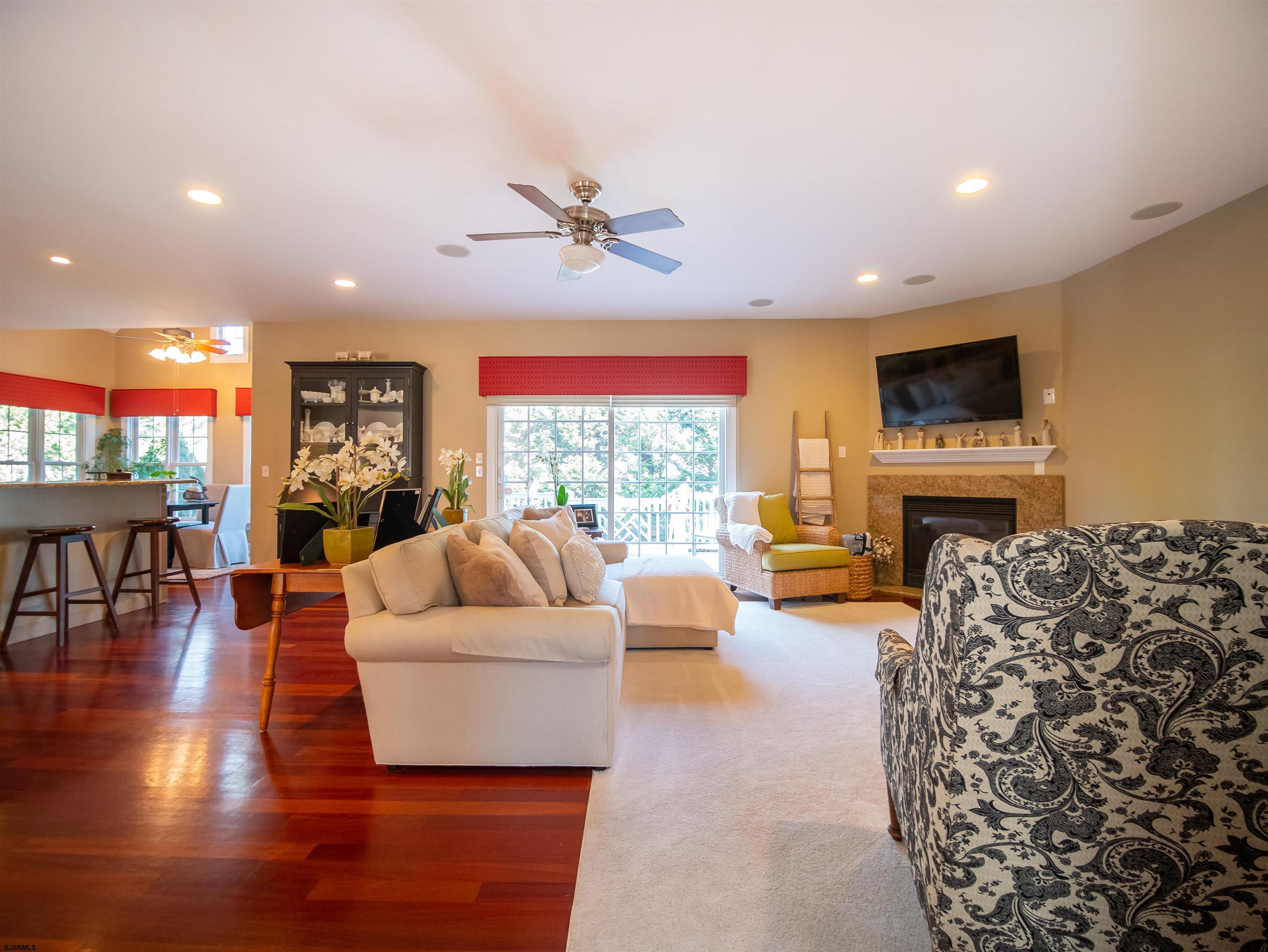 9 MGM Way Ocean View, NJ 08230 - Photo 21 of 61 a living room with furniture a fireplace and a flat screen tv