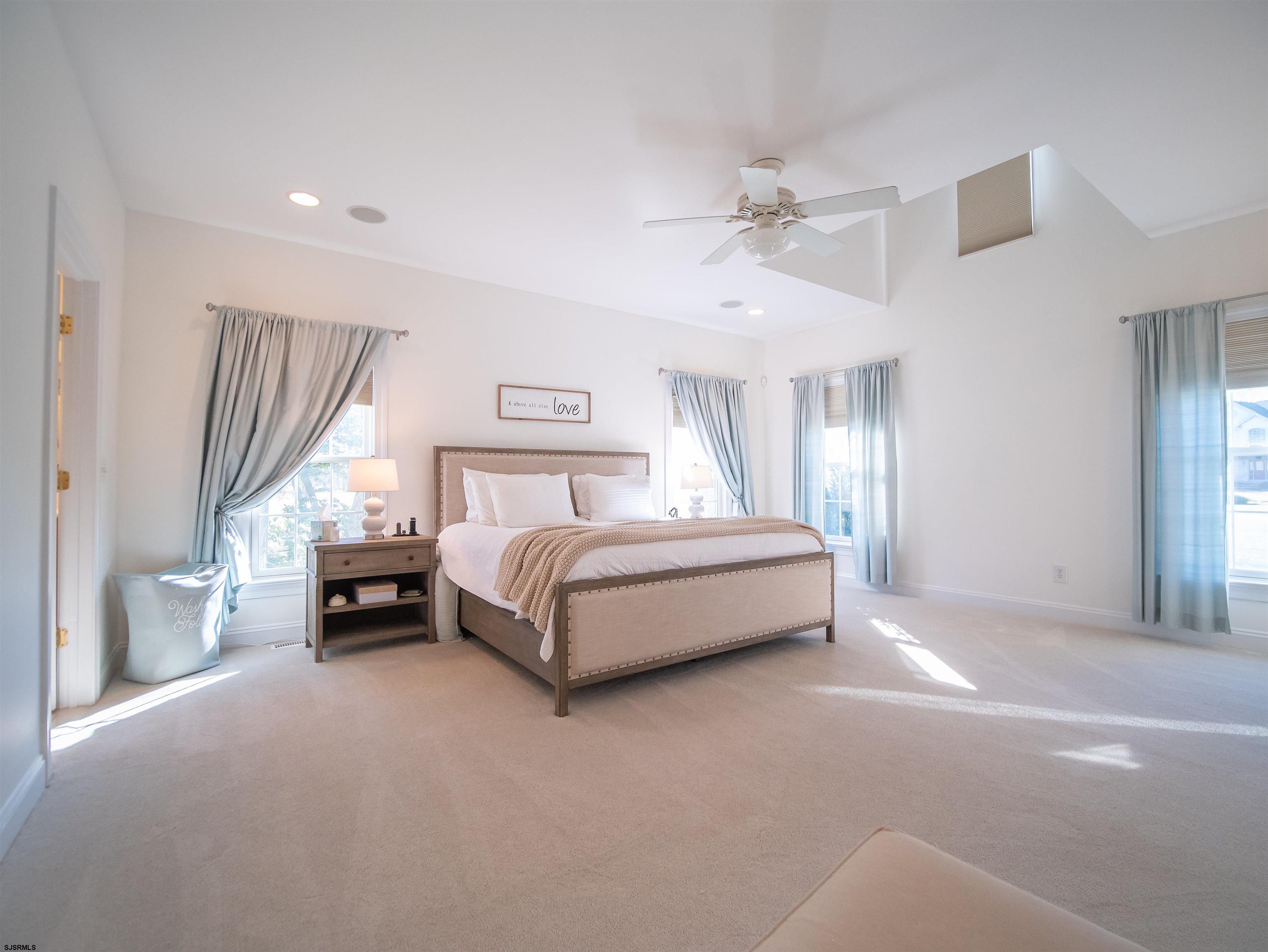 9 MGM Way Ocean View, NJ 08230 - Photo 27 of 61 a bedroom with a bed and a chandelier