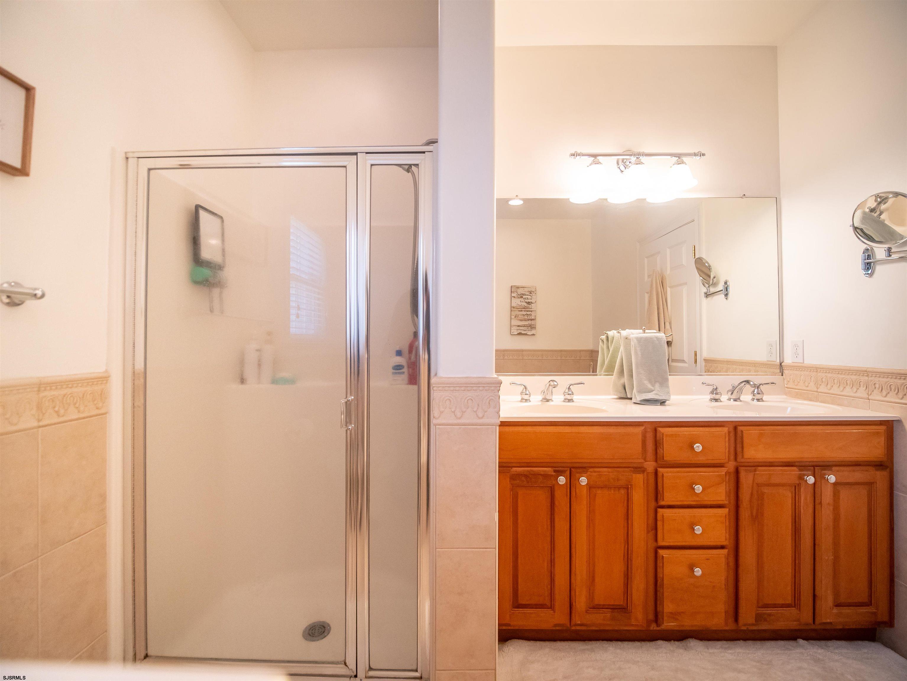 9 MGM Way Ocean View, NJ 08230 - Photo 30 of 61 a bathroom with a double vanity sink and a mirror