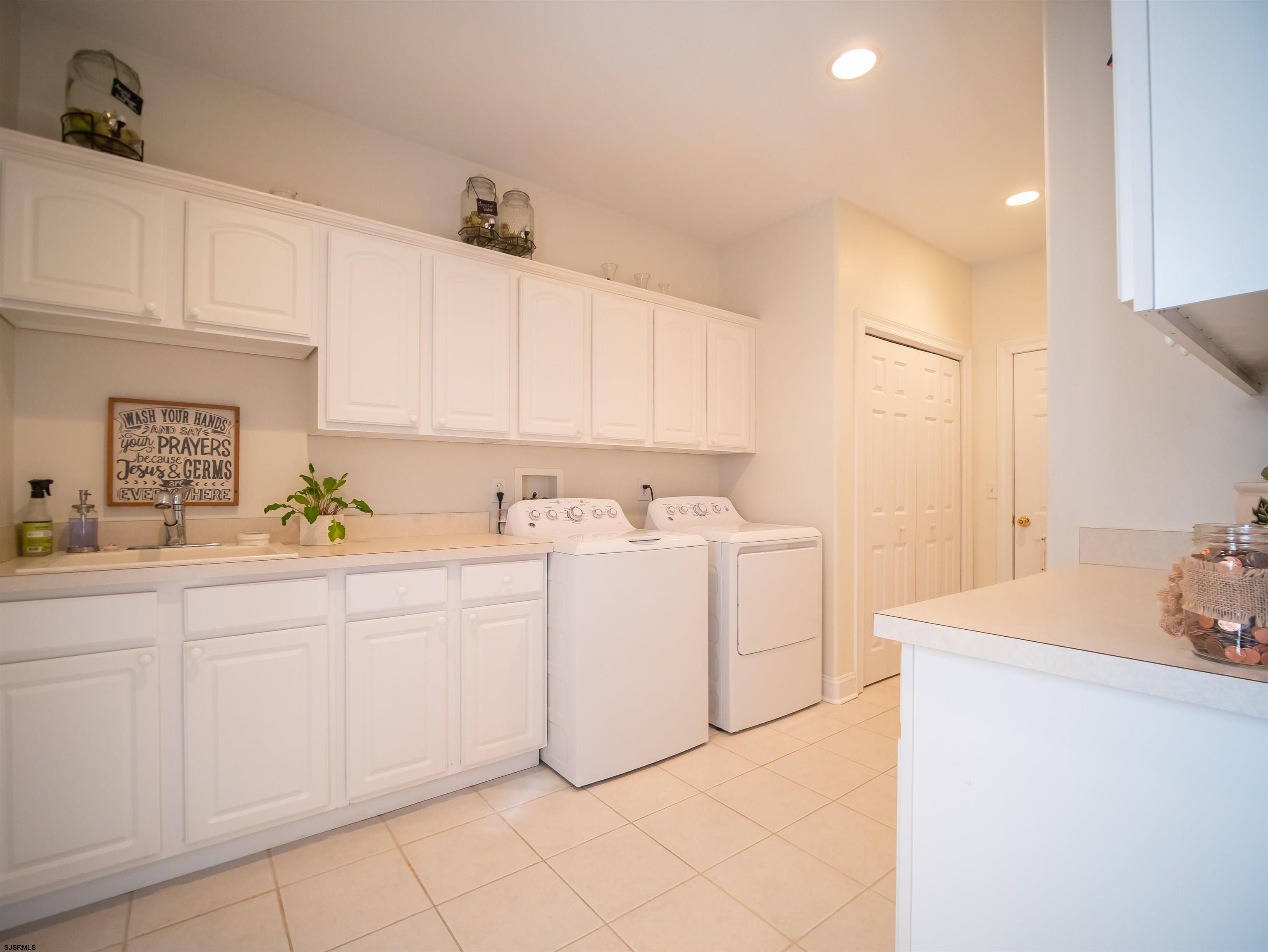 9 MGM Way Ocean View, NJ 08230 - Photo 33 of 61 a utility room with cabinets washer and dryer