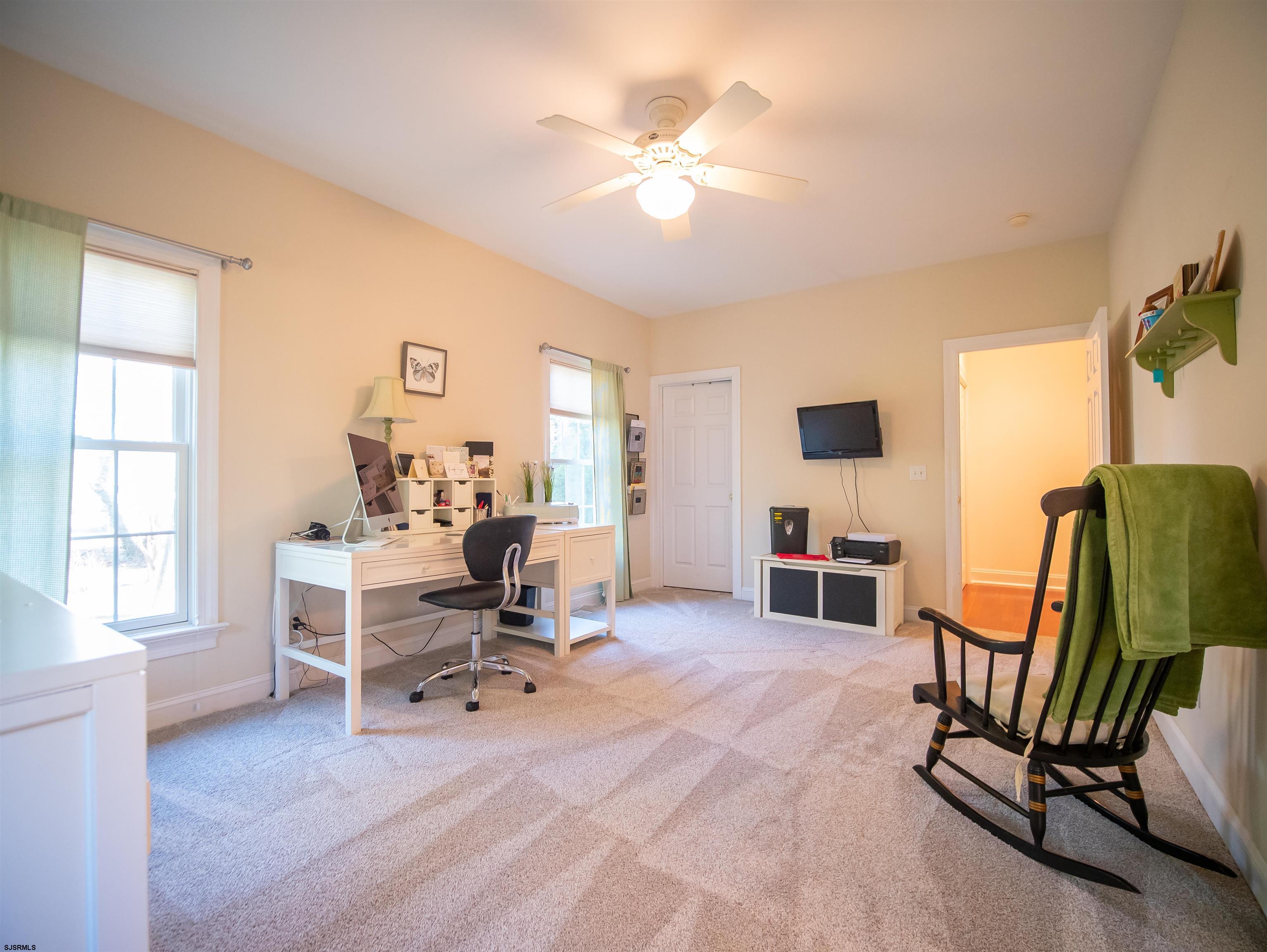 9 MGM Way Ocean View, NJ 08230 - Photo 35 of 61 a living room with furniture and a flat screen tv