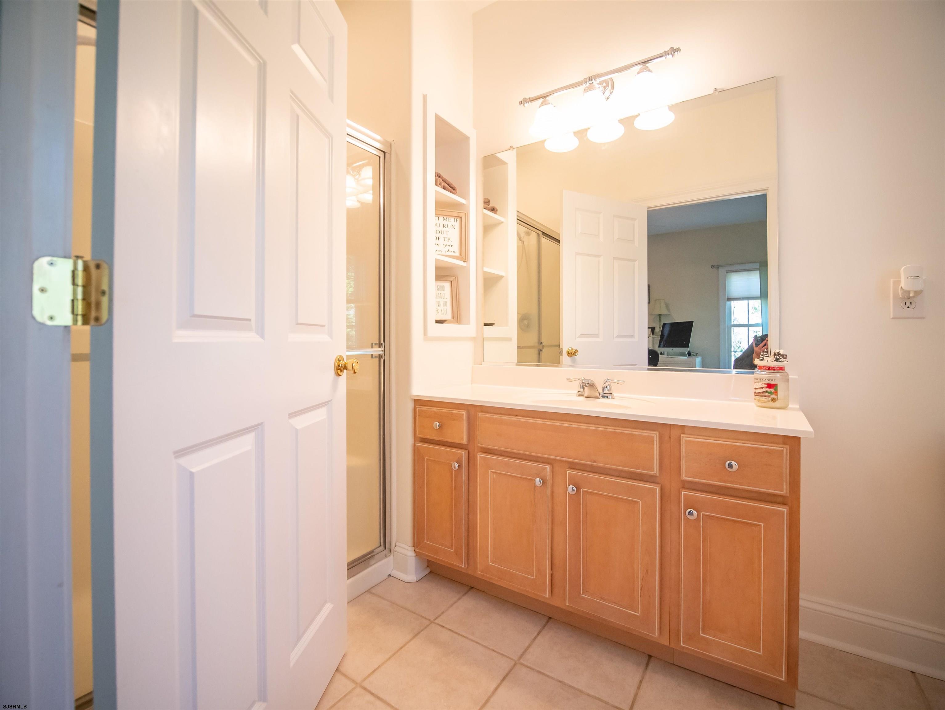 9 MGM Way Ocean View, NJ 08230 - Photo 37 of 61 a bathroom with a double vanity sink and a mirror