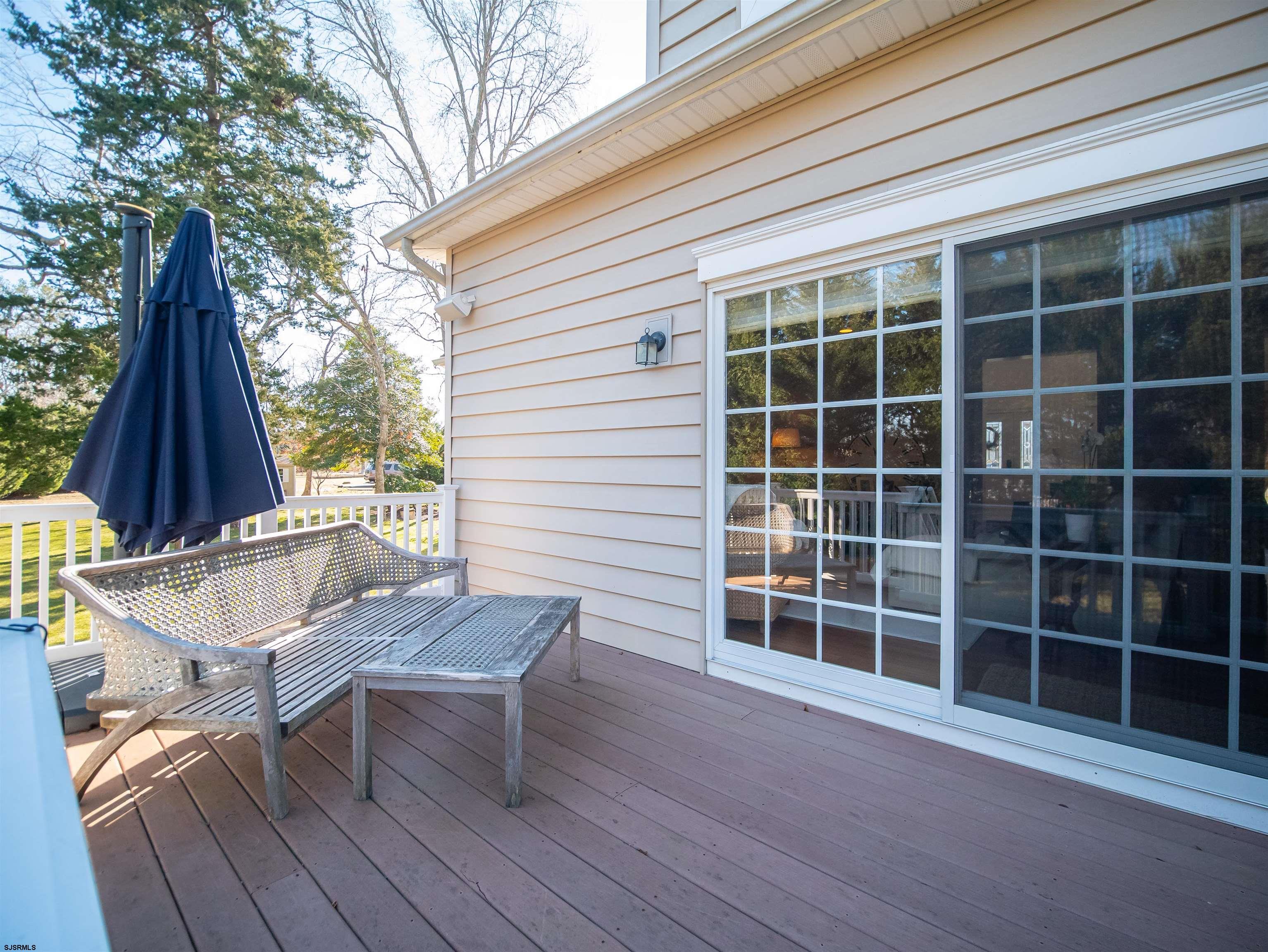 9 MGM Way Ocean View, NJ 08230 - Photo 50 of 61 a view of a deck with table and chairs and wooden floor