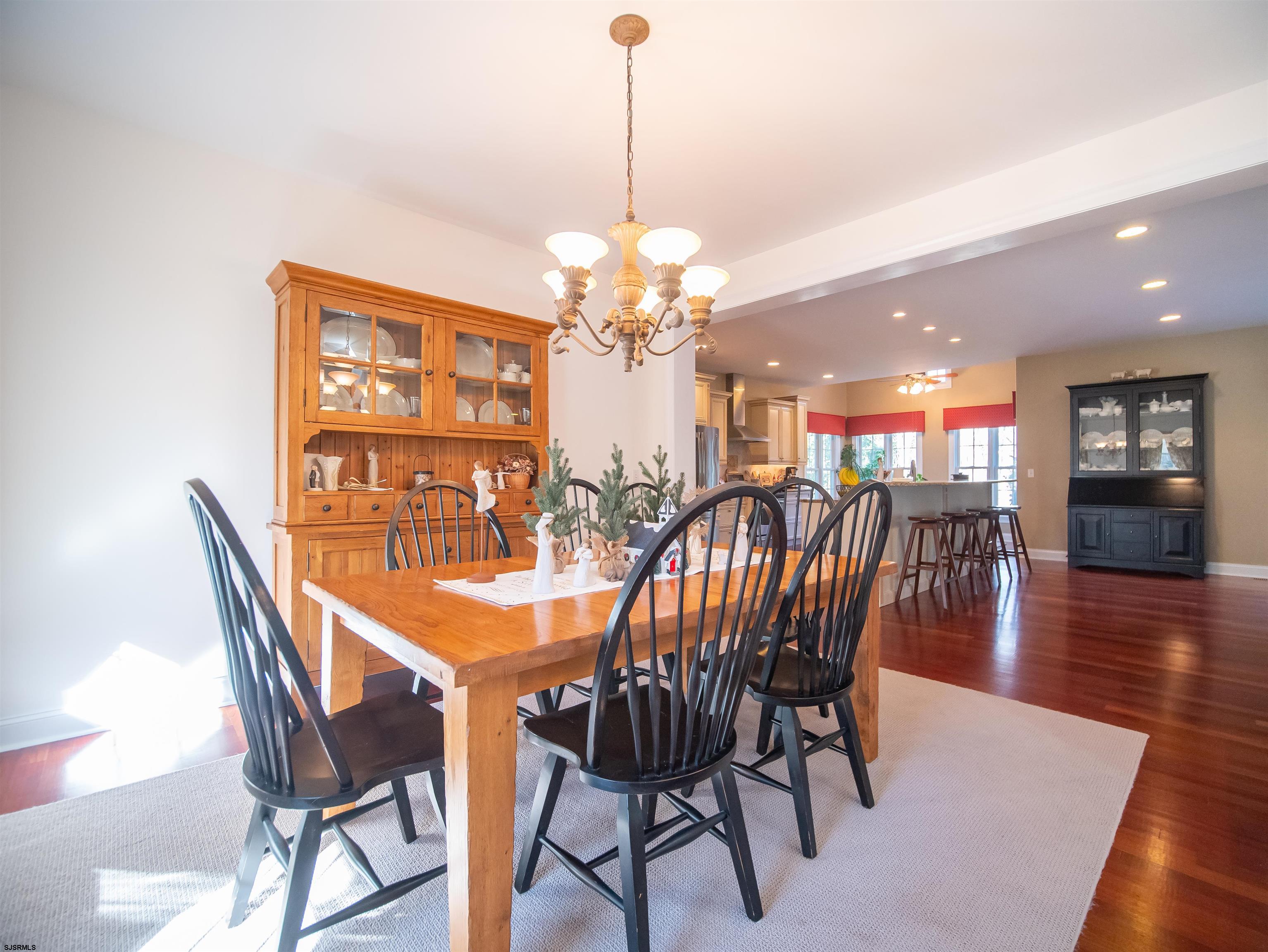 9 MGM Way Ocean View, NJ 08230 - Photo 8 of 61 a dining room with furniture wooden floor and a chandelier