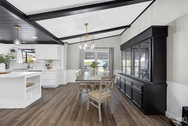 a kitchen with granite countertop lots of counter top space and wooden floors