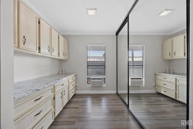 a kitchen with white cabinets and appliances