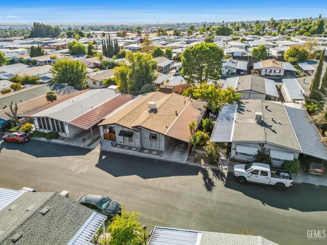 an aerial view of a houses with a city view