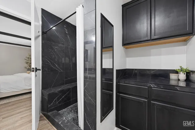 a bathroom with a shower and a sink