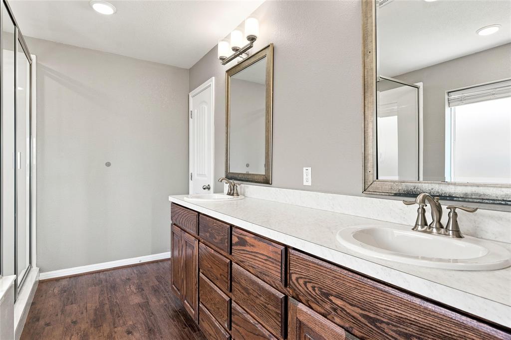 204 Raven Ridge Court Waco, TX 76705 - Photo 10 of 19 Dual vanity with wood-finish cabinetry, white countertops, and undermount sinks