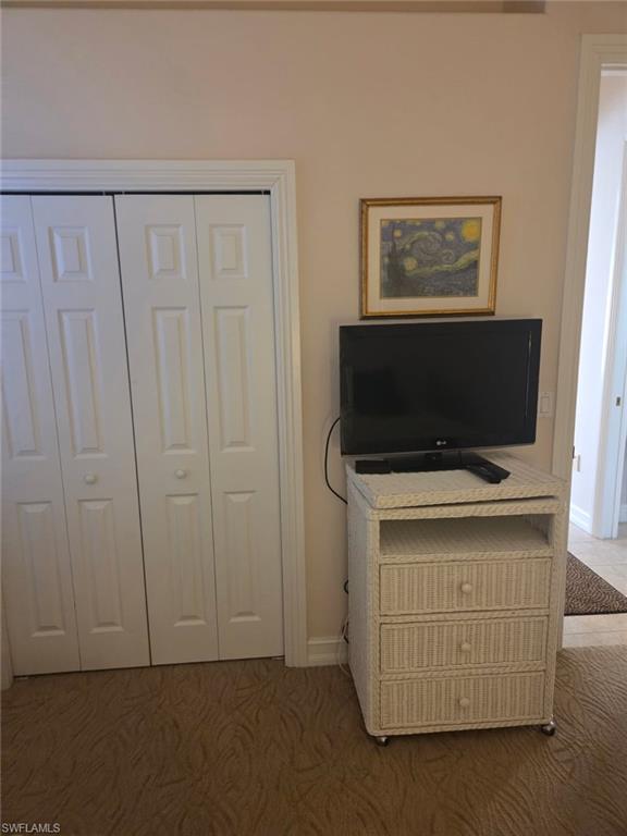 6719 Crowned Eagle Lane Naples, FL 34113 - Photo 14 of 23 a living room with a flat screen tv and a refrigerator
