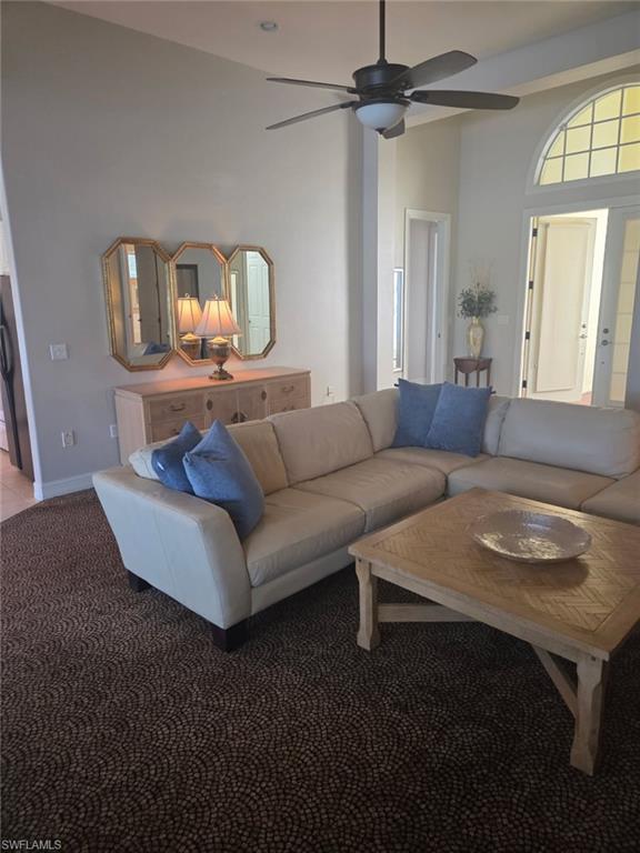 6719 Crowned Eagle Lane Naples, FL 34113 - Photo 17 of 23 a living room with furniture and a wooden floor
