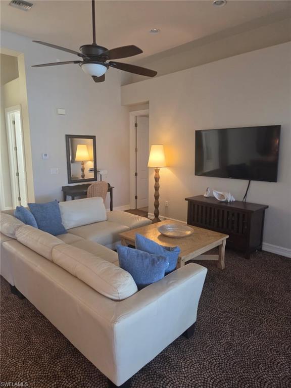 6719 Crowned Eagle Lane Naples, FL 34113 - Photo 20 of 23 a living room with furniture and a flat screen tv