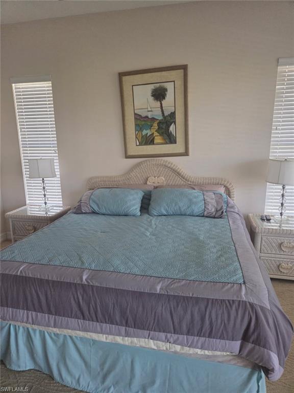 6719 Crowned Eagle Lane Naples, FL 34113 - Photo 3 of 23 a bedroom with a bed and a painting on the wall