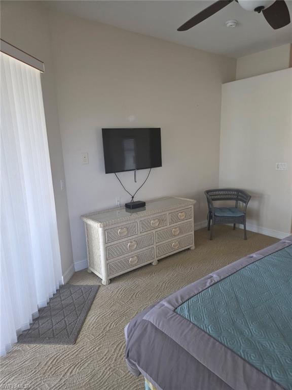 6719 Crowned Eagle Lane Naples, FL 34113 - Photo 4 of 23 a living room with furniture and a flat screen tv