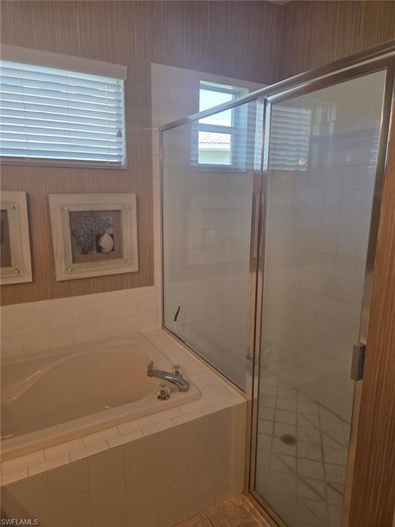 6719 Crowned Eagle Lane Naples, FL 34113 - Photo 6 of 23 a bathroom with a tub and a shower