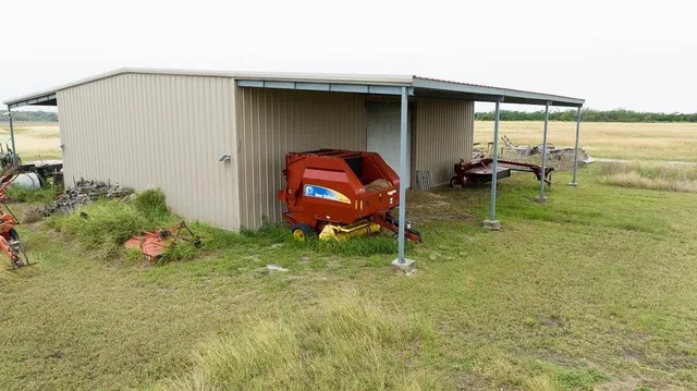 a backyard of a house with barbeque oven table and chairs