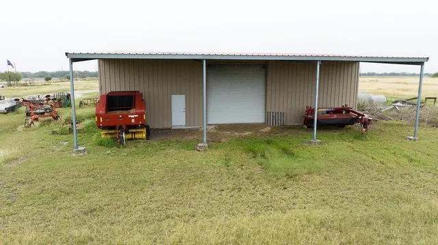 a backyard of a house with barbeque oven table and chairs