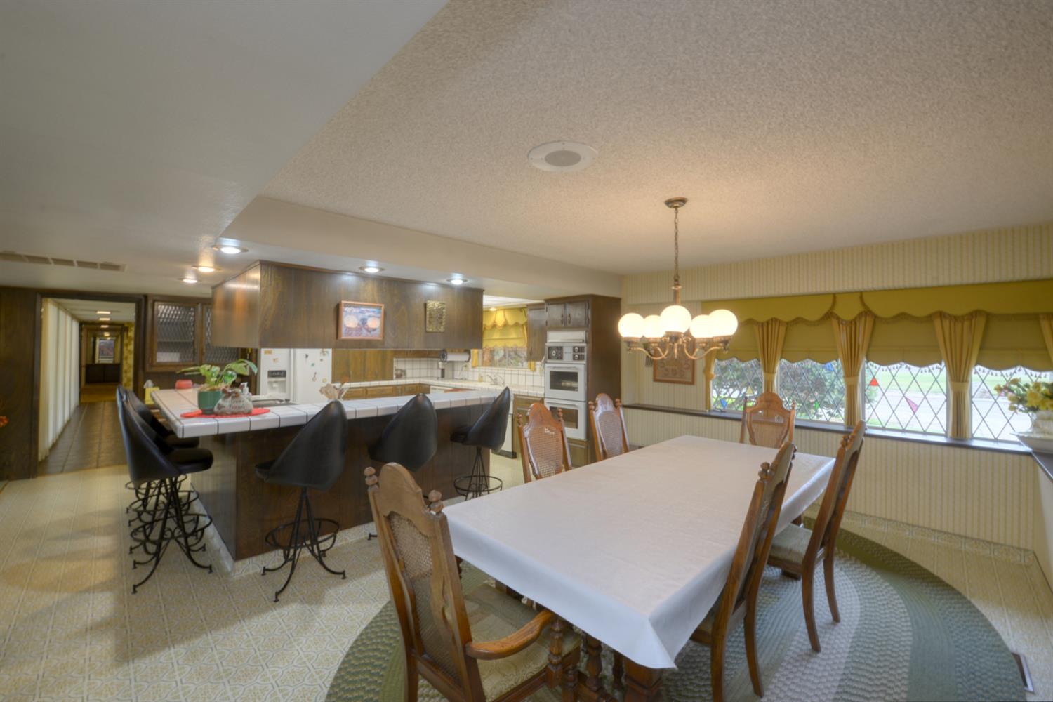 1471 Highway 33 Gustine, CA 95322 - Photo 16 of 57 a dining room with a table chairs and a kitchen view
