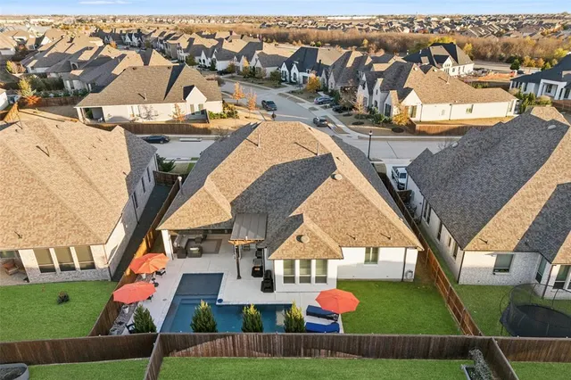 an aerial view of residential houses with outdoor space