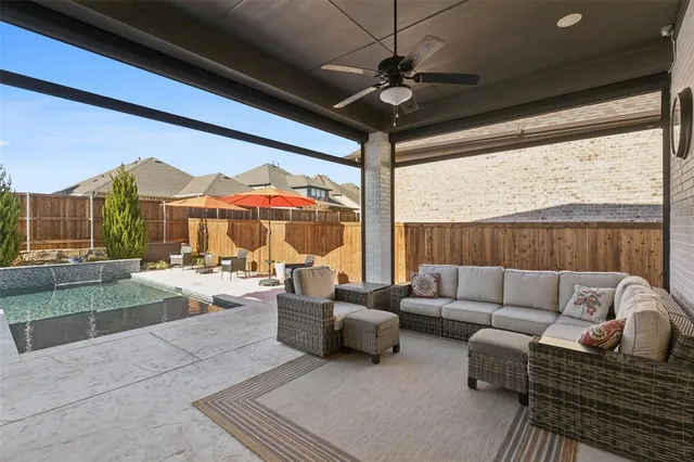 a view of a house with a big yard potted plants and large tree