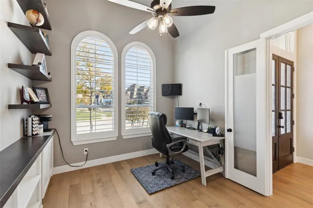 a living room with furniture a flat screen tv and a large window