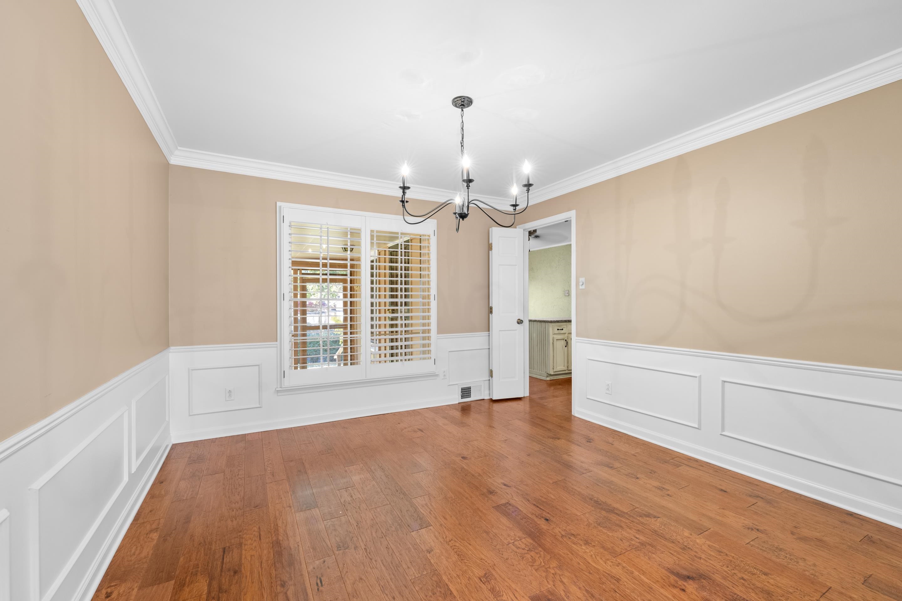 1751 Magnolia Tree Road Germantown, TN 38138 - Photo 11 of 36 a view of an empty room with chandelier and wooden floor