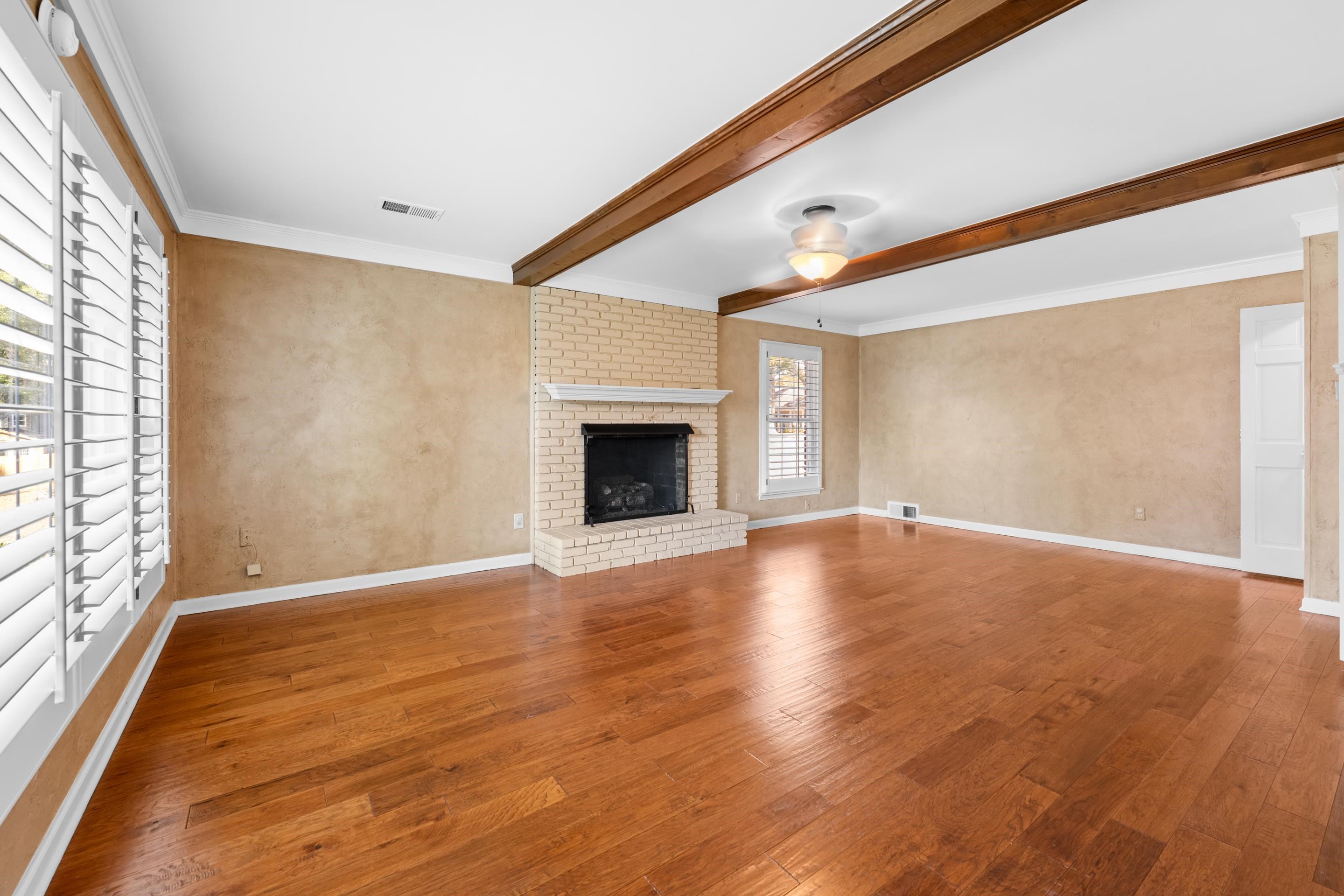 1751 Magnolia Tree Road Germantown, TN 38138 - Photo 18 of 36 a view of empty room with wooden floor and fireplace