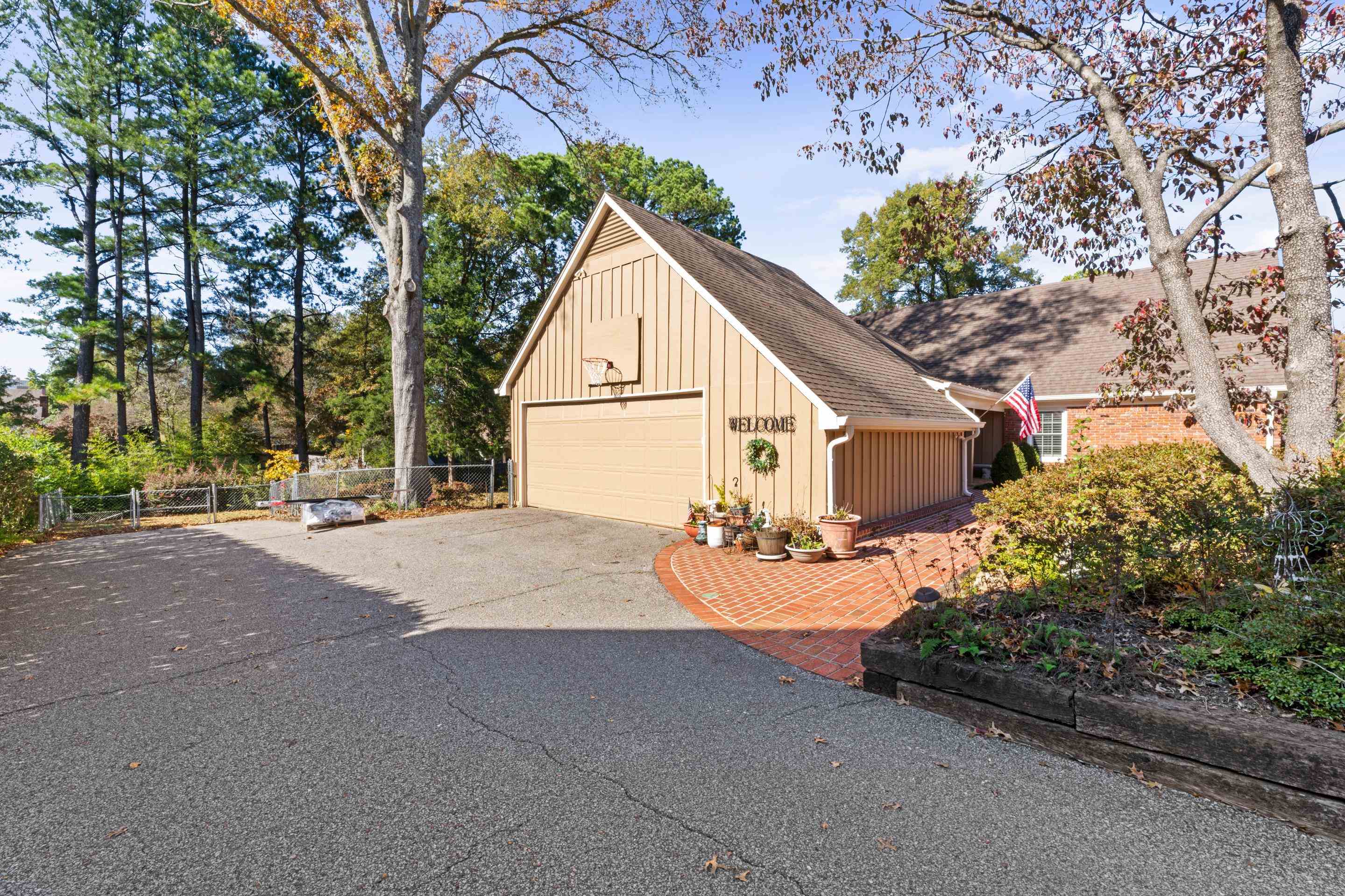 1751 Magnolia Tree Road Germantown, TN 38138 - Photo 5 of 36 a view of a house with a yard and garage