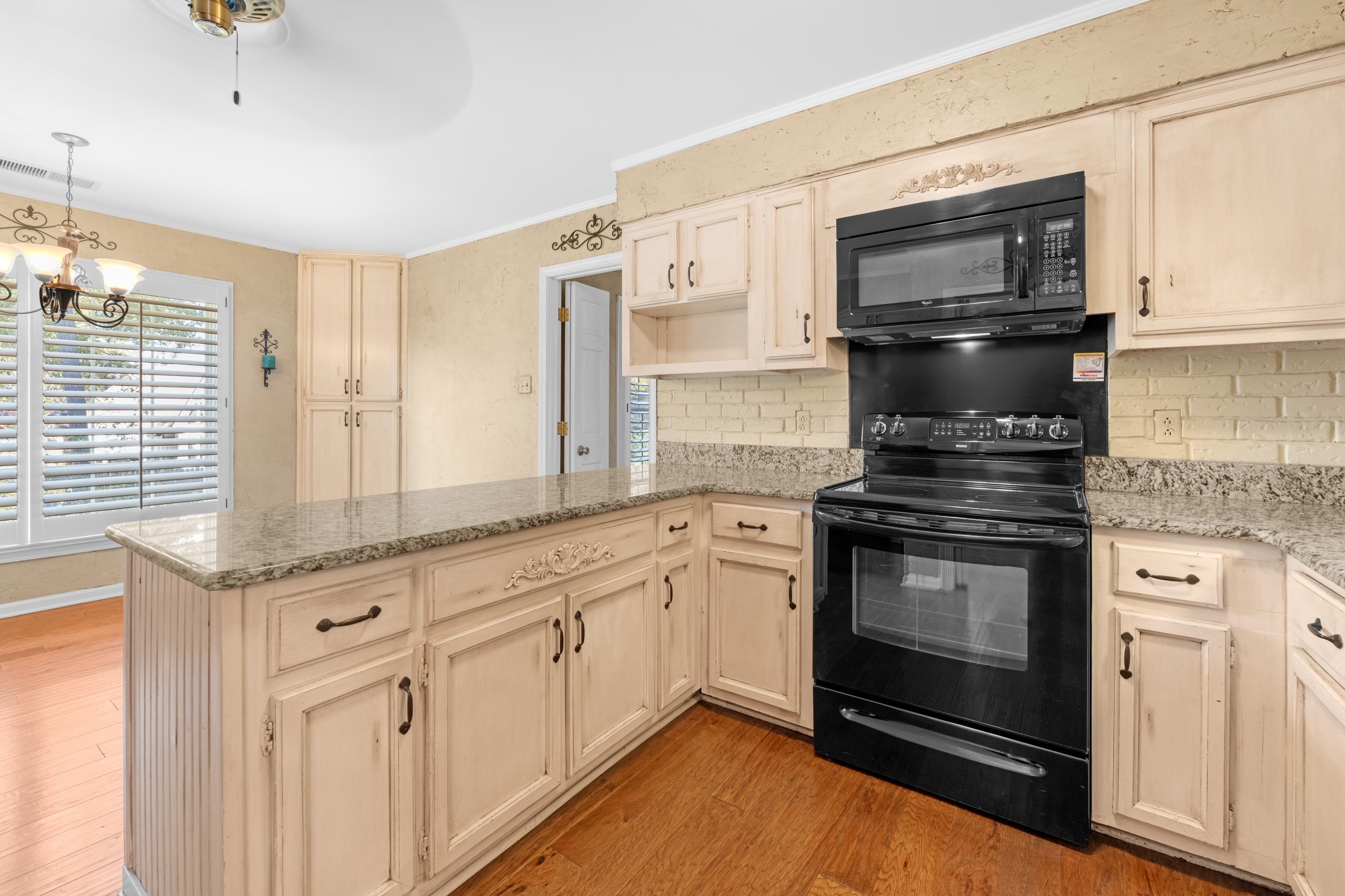 1751 Magnolia Tree Road Germantown, TN 38138 - Photo 7 of 36 a kitchen with granite countertop white cabinets stainless steel appliances and a sink