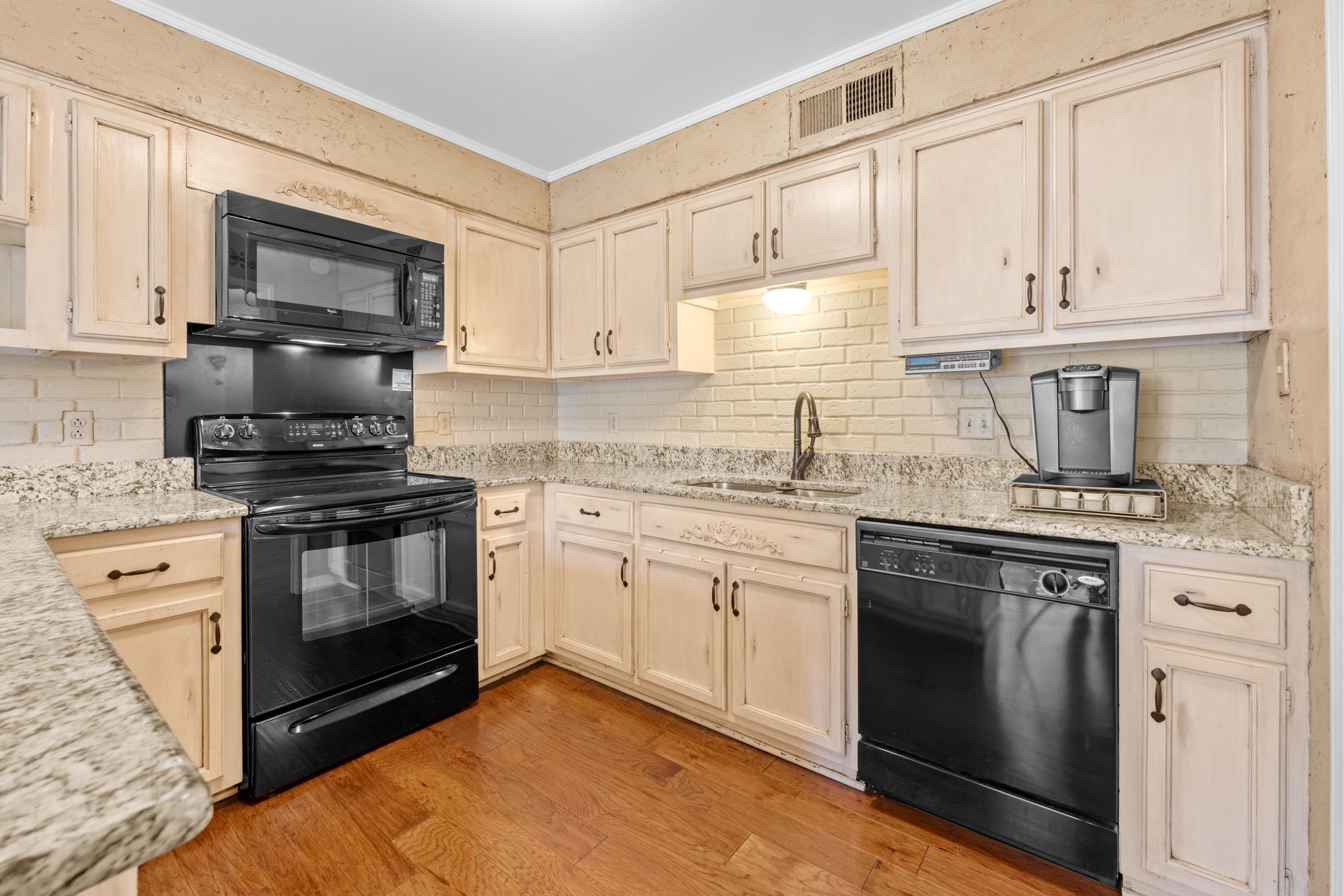 1751 Magnolia Tree Road Germantown, TN 38138 - Photo 8 of 36 a kitchen with granite countertop white cabinets stainless steel appliances and a sink